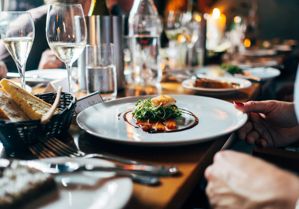 A plated meal at a candlelit restaurant table
